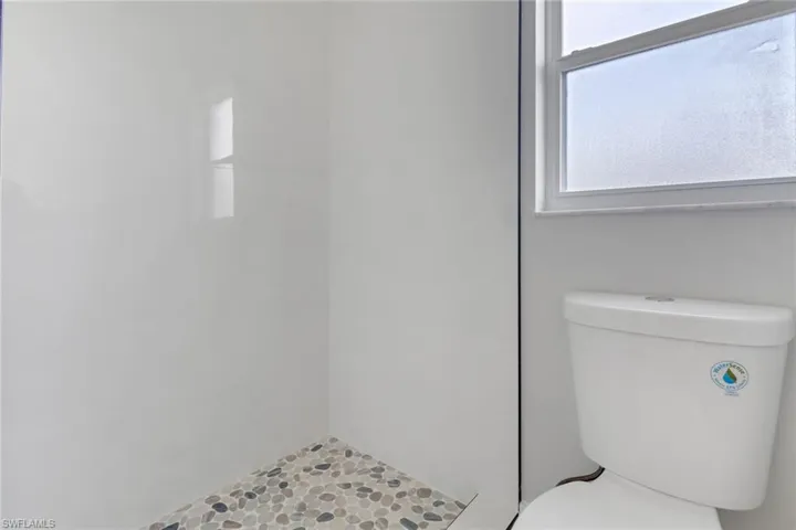 Bathroom featuring a shower and toilet