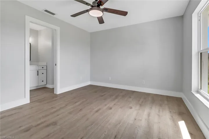 Spare room featuring ceiling fan and light wood-type flooring