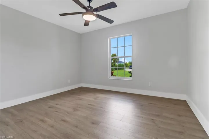 Spare room with light hardwood / wood-style flooring and ceiling fan