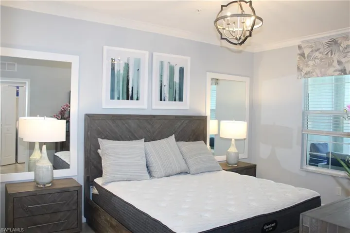 Bedroom with a chandelier and ornamental molding