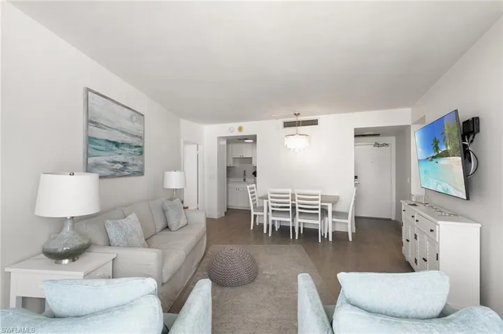Living room featuring visible vents and wood finished floors