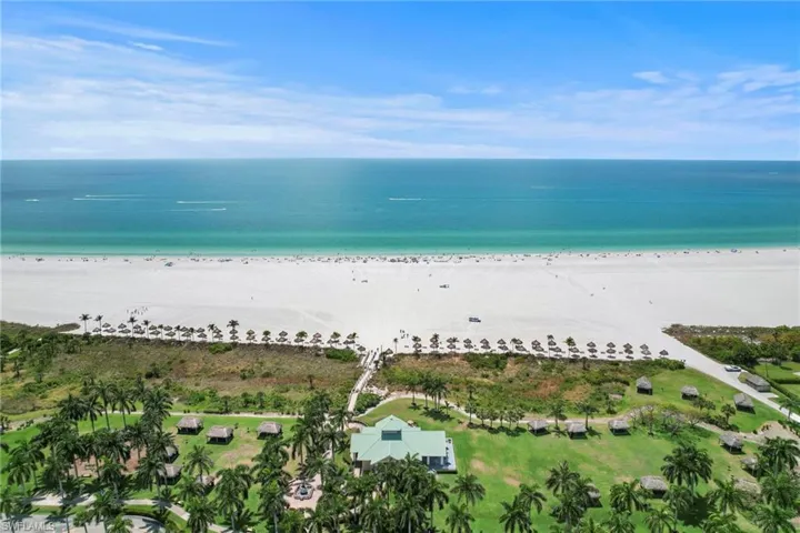 Aerial view featuring a water view and a view of the beach