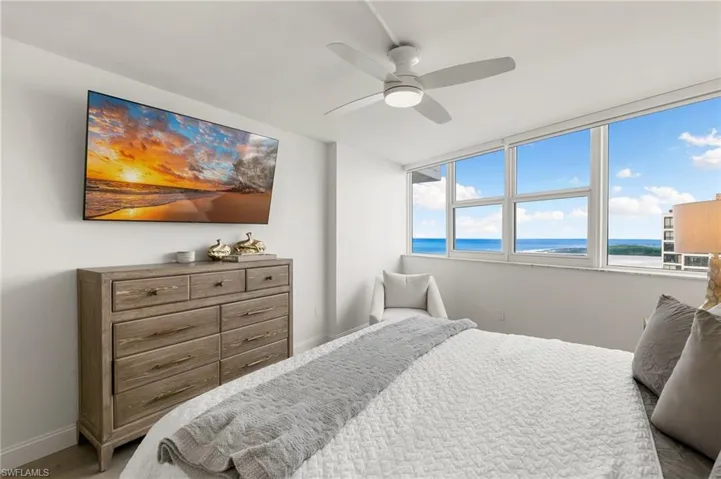 Bedroom featuring ceiling fan and baseboards