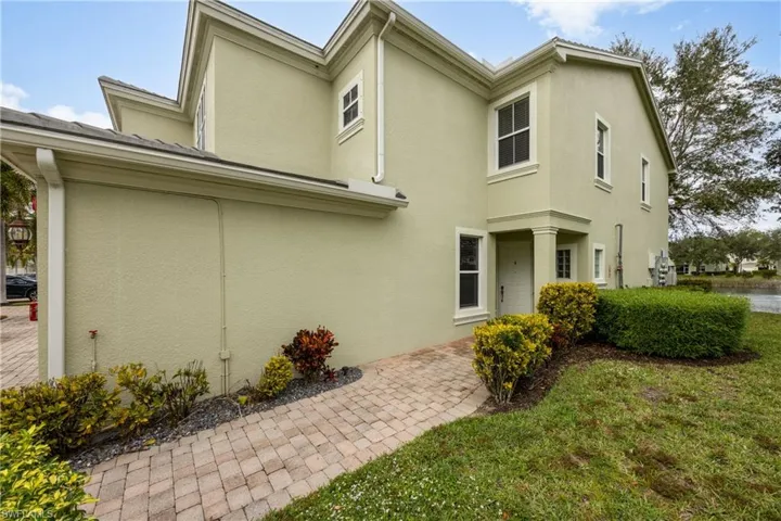 View of side of property with stucco siding and a yard