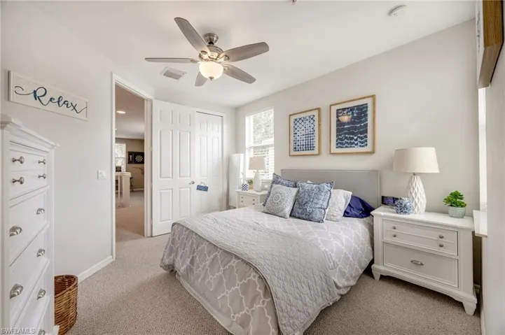 Bedroom featuring light carpet, a closet, and ceiling fan