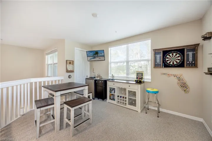 Dining space with light colored carpet
