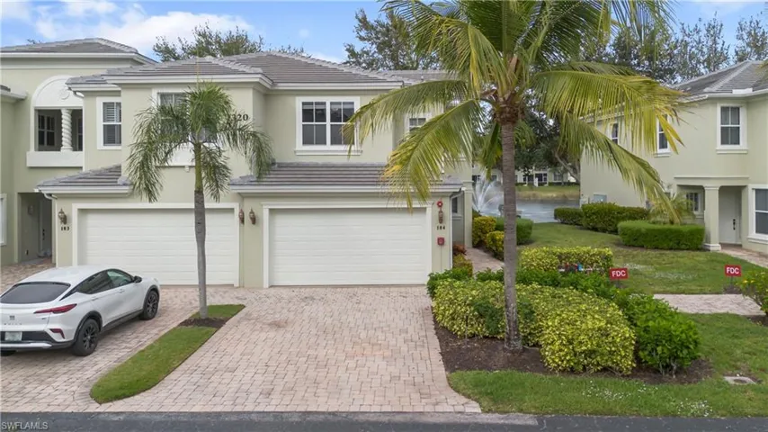 View of front of home featuring stucco siding, decorative driveway, an attached garage, and a tile roof