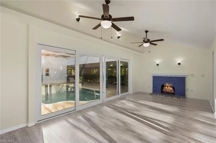 Family room with gas fireplace and slider to the pool