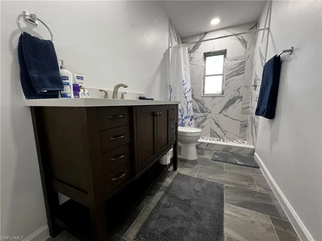 2nd Bathroom featuring vanity, toilet, and walk in shower