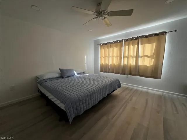 Master Bedroom featuring walk-in closing and ensuite adjoining master bathroom and ceiling fan