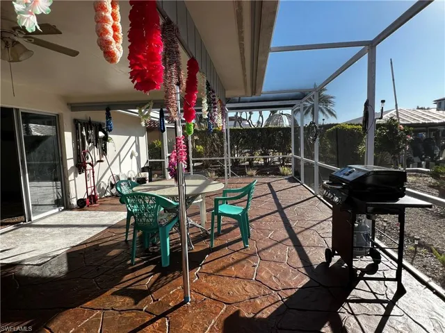 View of patio with area for grilling and a lanai