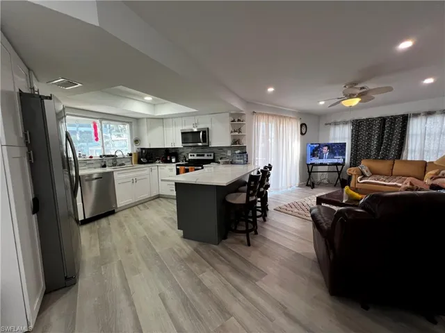 Kitchen featuring sink, appliances with stainless steel finishes, and decorative backsplash