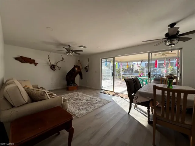 Living room featuring ceiling fan and plenty of natural light