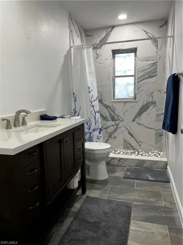 2nd Bathroom with vanity, a shower with curtain, and toilet