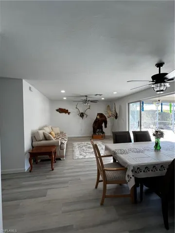 Dining area featuring ceiling fan and wood-type flooring