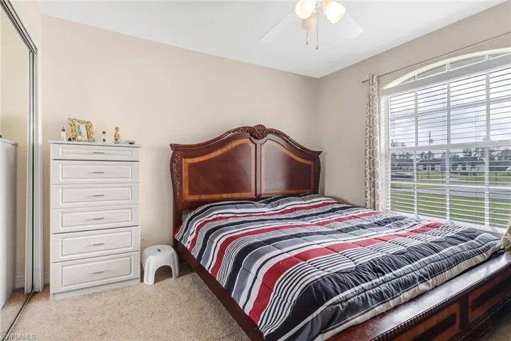 Carpeted bedroom with ceiling fan