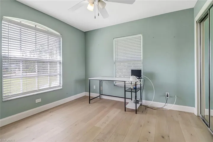 Office space featuring ceiling fan and light hardwood / wood-style flooring