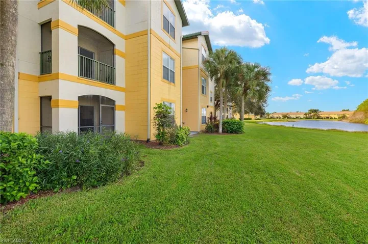 View of yard featuring a water view and a balcony.