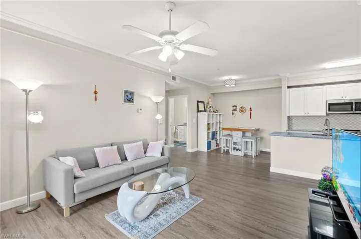 Open concept kitchen and living room with neutral color palette.