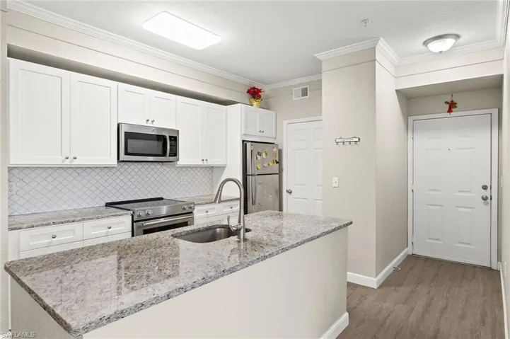 Laundry room door next to the refrigerator. Newer washer and dryer to convey as well.