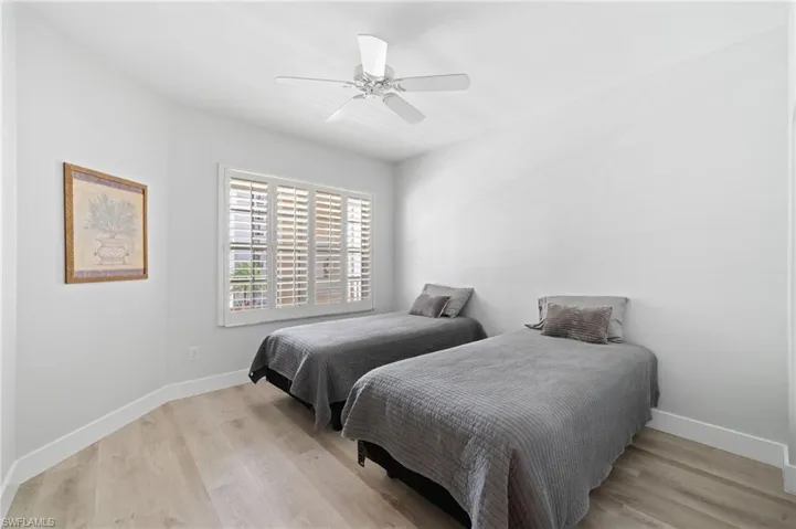 Bedroom with light wood-type flooring and a ceiling fan