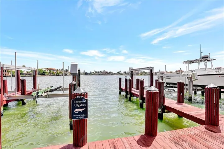 Dock featuring boat lift and a water view