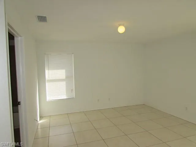 Spare room featuring light tile patterned floors