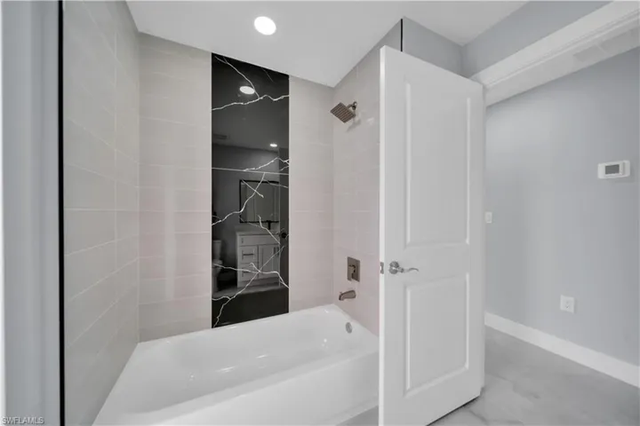 Full bathroom featuring shower / bathtub combination and recessed lighting