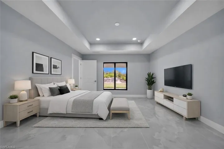 Bedroom with a raised ceiling and recessed lighting
