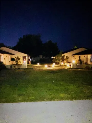 Yard at twilight featuring a yard
