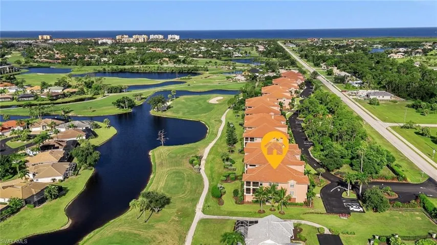 Drone / aerial view with view of golf course and a water view