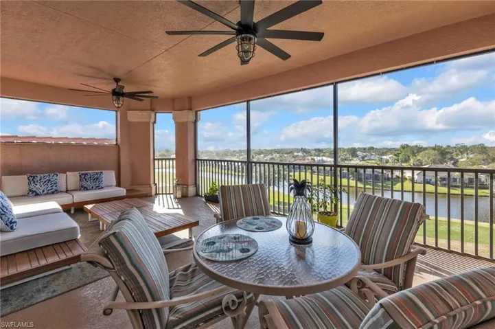 Sunroom / solarium with a water view and ceiling fan
