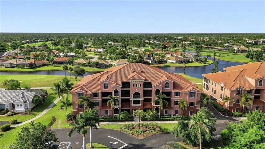 Drone / aerial view with golf course view, a water view, and a residential view