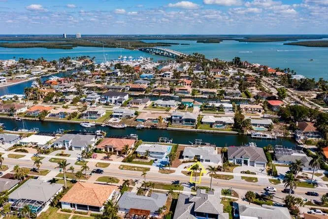 Birds eye view of property with a residential view and a water view