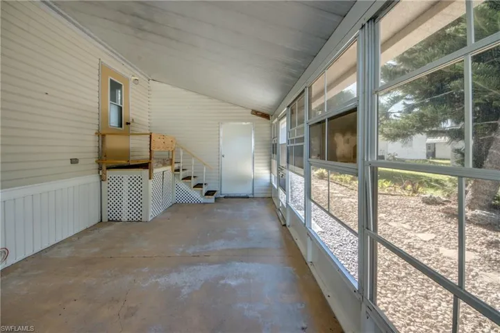 Enclosed sunroom with expansive windows, providing exterior views