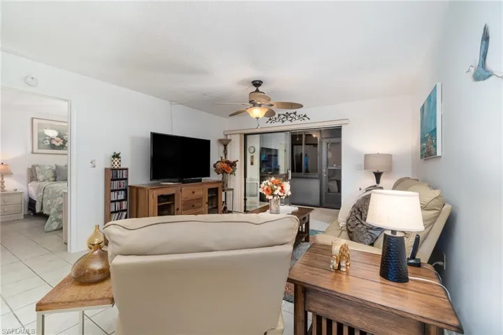 Living room featuring ceiling fan and light tile patterned flooring