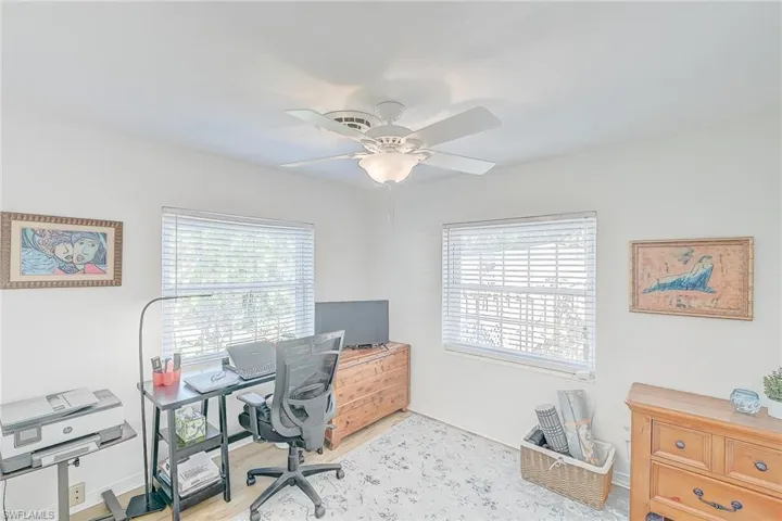 Office with ceiling fan and light hardwood / wood-style flooring