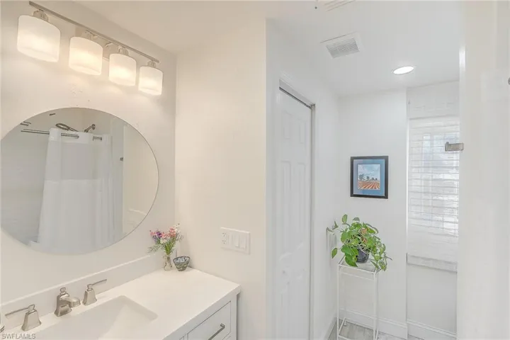 Bathroom featuring vanity and a shower