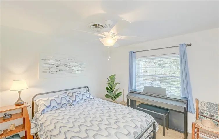 Bedroom with ceiling fan and light hardwood / wood-style floors
