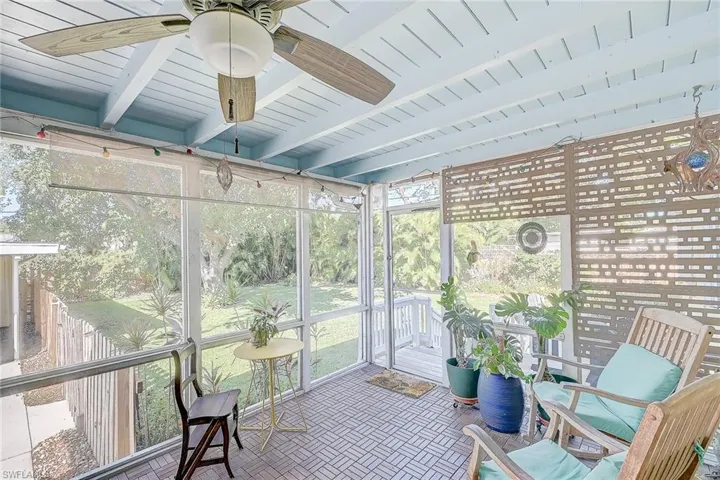 Sunroom / solarium with beamed ceiling, ceiling fan, and wooden ceiling