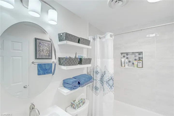 Bathroom with sink and a shower with shower curtain