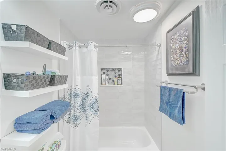 Bathroom featuring shower / bath combination with curtain