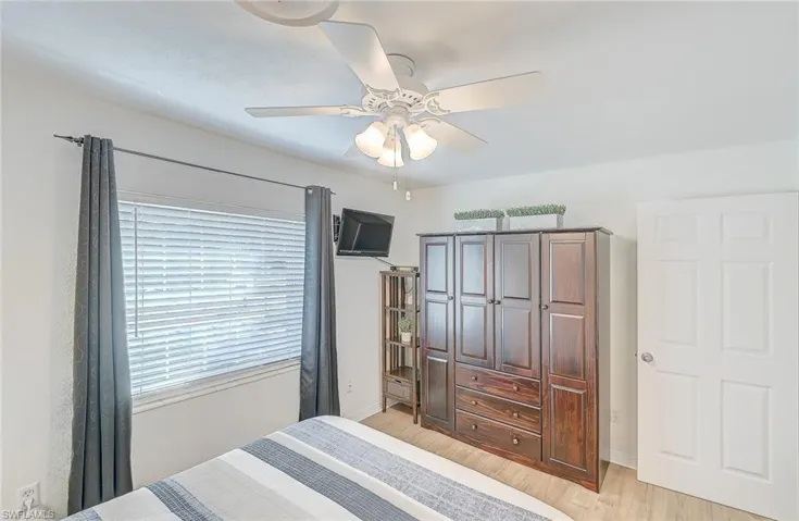 Bedroom featuring ceiling fan and light hardwood / wood-style flooring