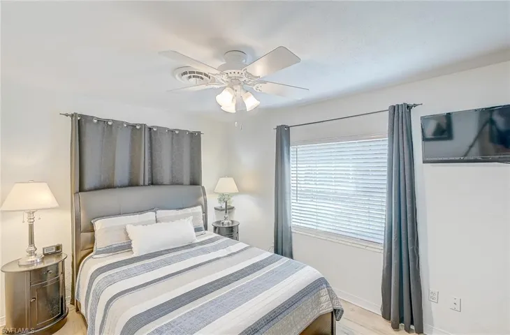 Bedroom with ceiling fan and light wood-type flooring