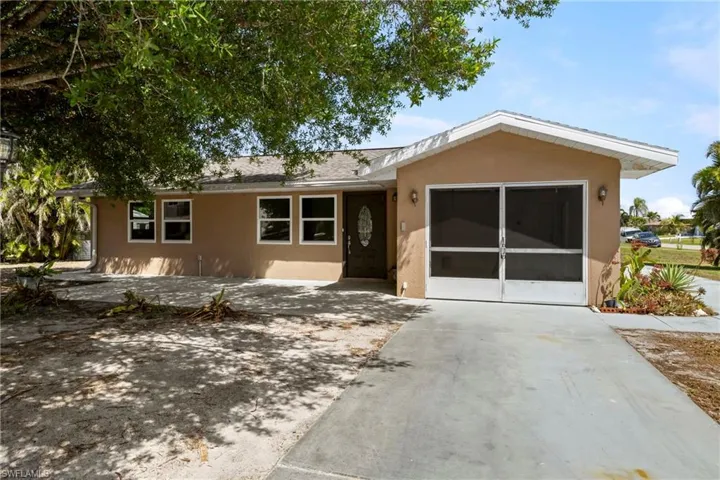 Single story home featuring concrete driveway, stucco siding, and an attached garage
