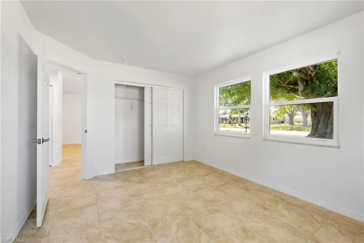 Unfurnished bedroom with a closet and baseboards