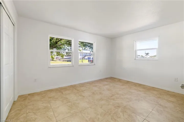 Unfurnished bedroom with a closet and baseboards
