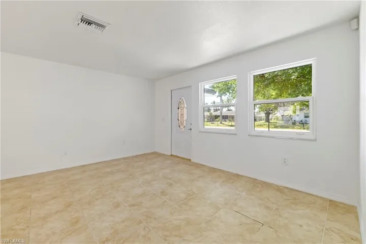 Spare room with baseboards and visible vents