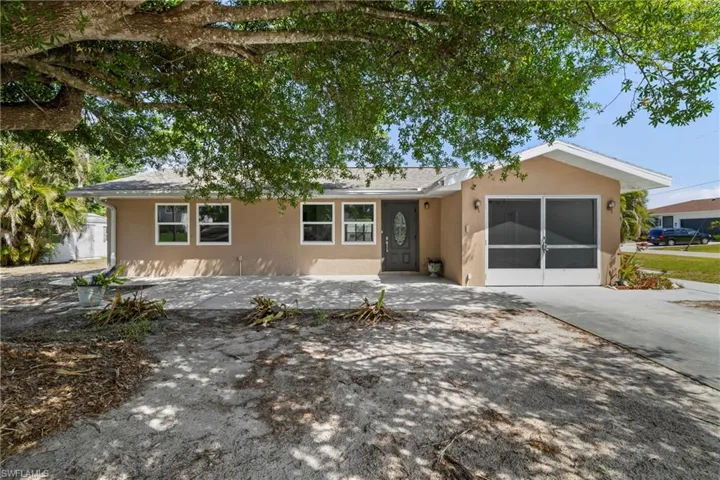 Ranch-style house with concrete driveway, stucco siding, and an attached garage