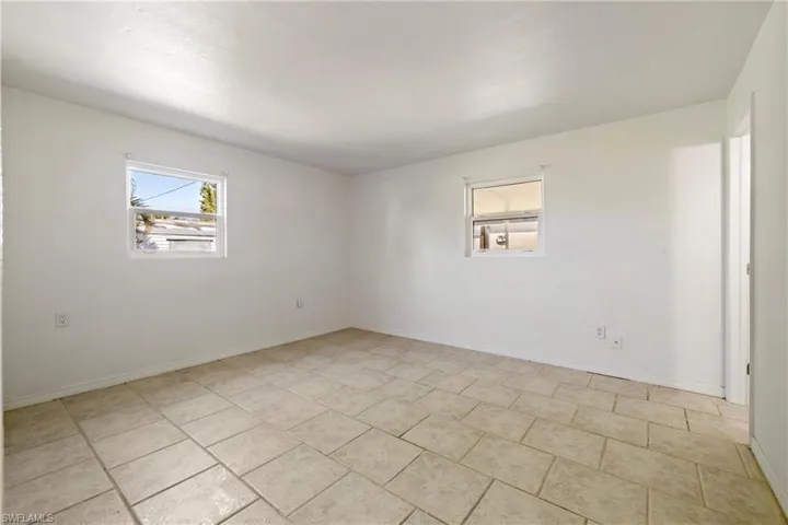 Empty room featuring baseboards